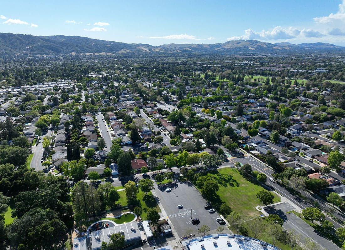 Pleasanton, CA - Aerial View of Homes and Commercial Buildings Surrounded by Green Foliage on a Sunny Day in Pleasanton California